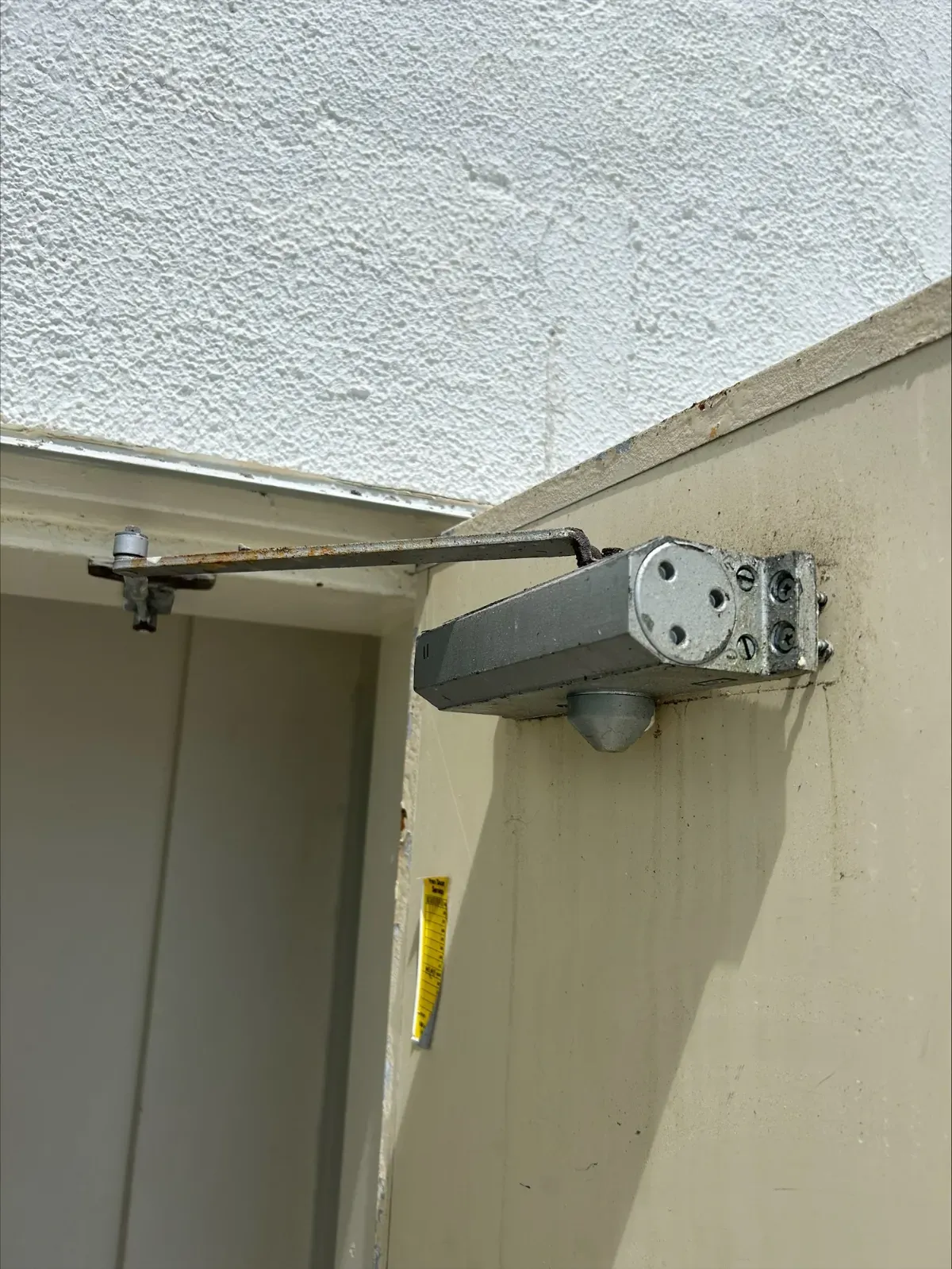 Corroded fire door closer hardware